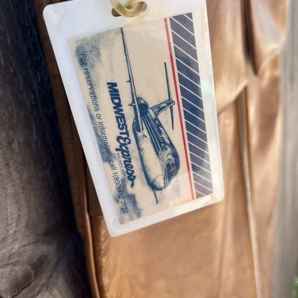 Vintage leather carry on for hanging clothes.